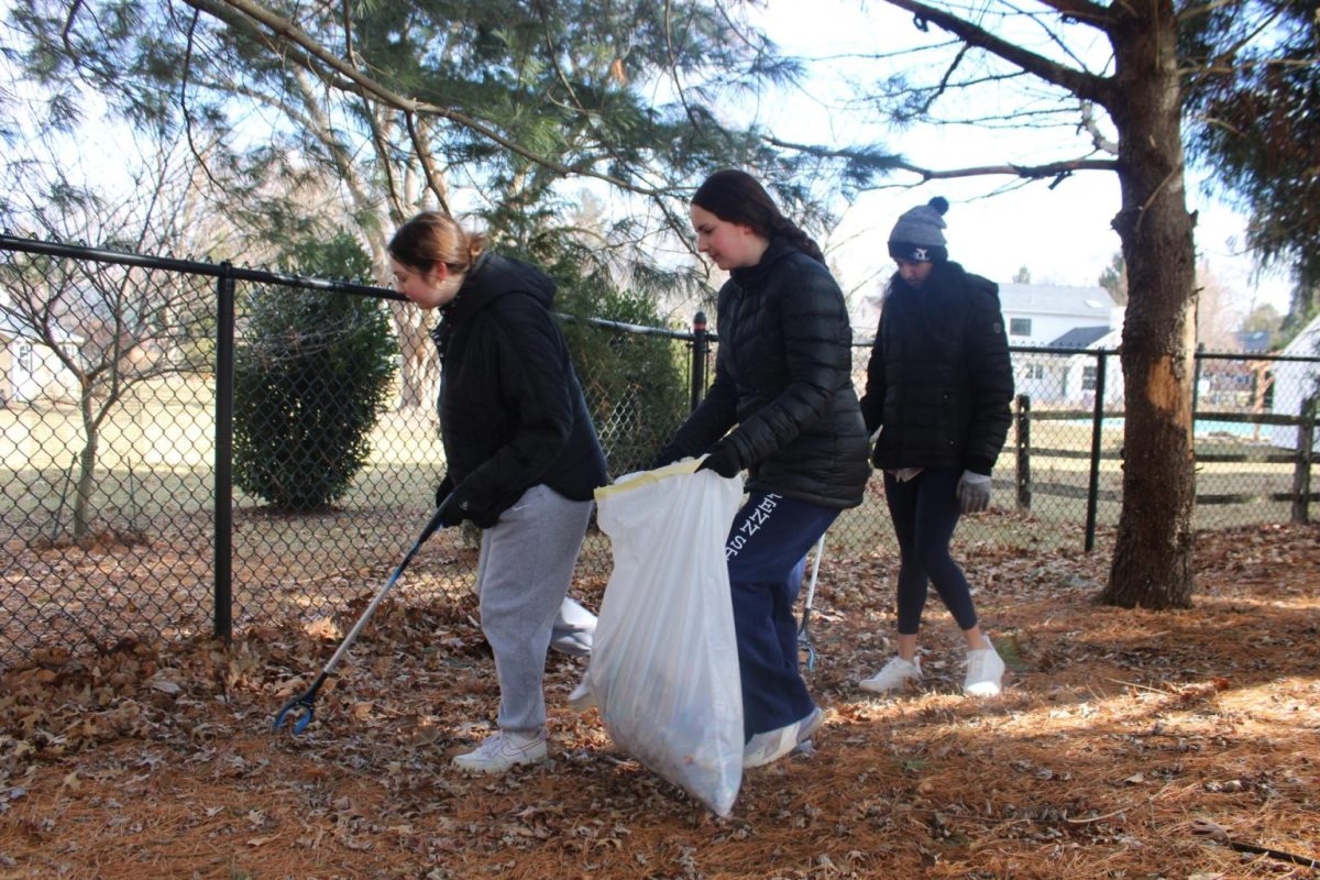 Community cleanup: Volunteers pick up trash behind Valley Forge Elementary School. The Tredyffrin Environmental Advisory Council organized the event aiming to improve the local community. 